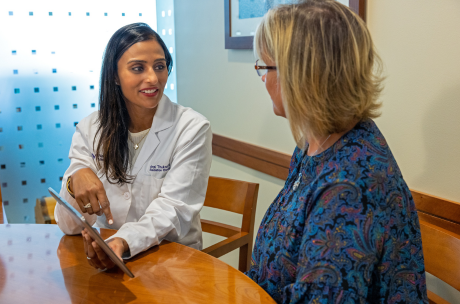 Northwestern Medicine Proton physician Doctor Thukral with a blonde hair patient.